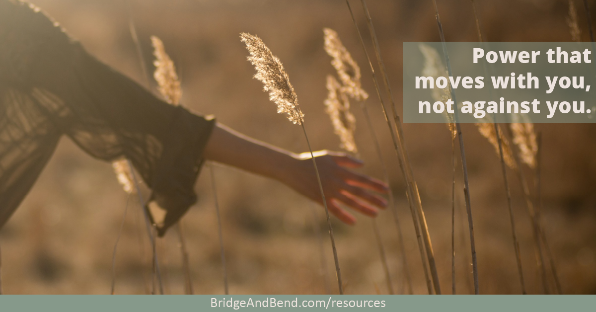 A woman stretches out her arm as she walks through a field of grass. Overlay text reads: "Power that moves with you, not against you."
